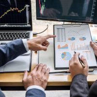 Business team investment working with computer, planning and analyzing graph stock market trading with stock chart data, business financial investment and technology concept.